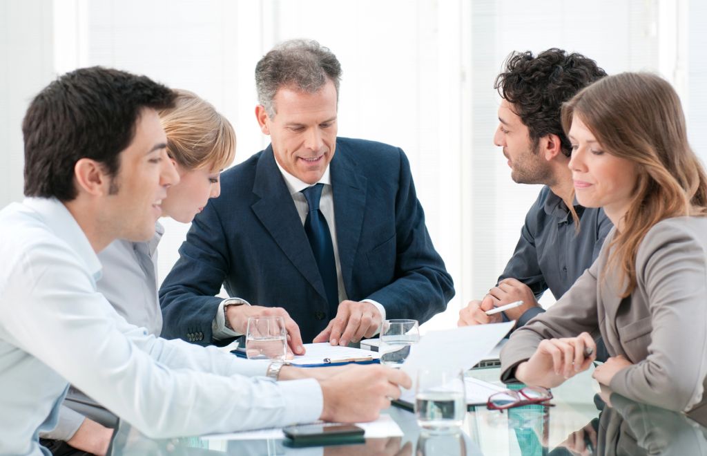 Person writing on a paper next to a lawyers statue