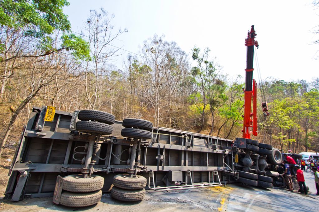 Damaged white truck with a semi-trailer